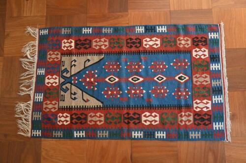 RUGS: A handwoven native American blue ground wool rug, USA<br />177 x 103cm