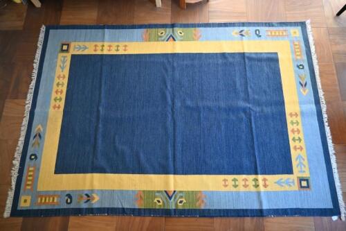 RUGS: A blue ground rug with yellow and pale blue border with geometric patterns<br />270 x 175cm