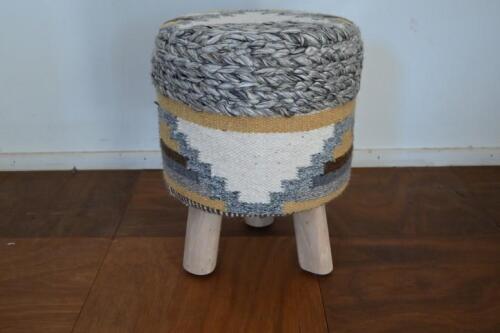 STOOL: A contemporary handwoven wool upholstered stool on wooden tripod base