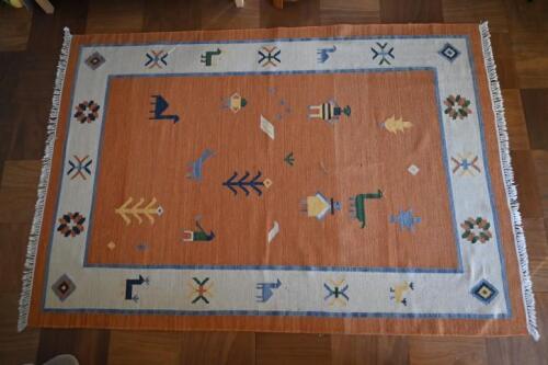 RUGS: A large South American style orange ground rug, with cream border , 263 x 185cm