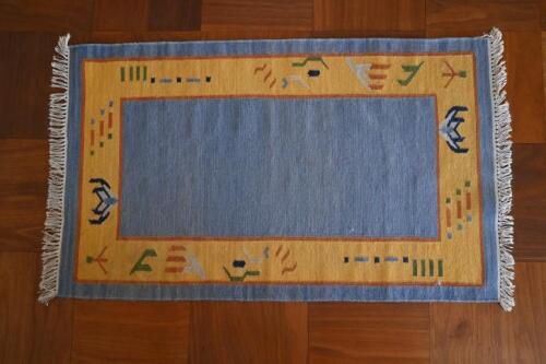 RUGS: A pale blue ground rug, with yellow geometric border, 146 x 89cm