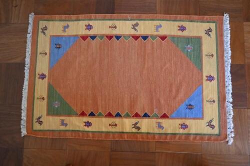 RUGS: A South American style orange ground rug, with yellow border , 178 x 114cm