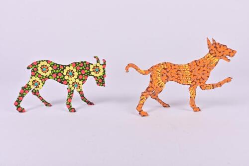 INDIGENOUS ARTWORK: Two painted metal dingo form sculptures, the tallest 12cm high
