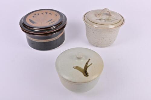 POTTERY: A collection of three ceramic lidded jars, the largest 18cm diameter