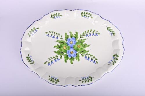 POTTERY: A large floral and foliate decorated platter by Primo, 56cm wide, 42cm deep