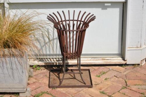 A wrought iron fire hearth with metal ash pan, 66cm high, 45cm wide *(see note)