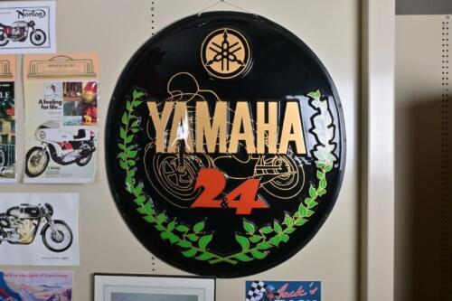 YAMAHA: An impressive 1970&rsquo;s &lsquo;YAMAHA & 24&rsquo; large embossed circular plastic showroom display wall sign, featuring a TZ like racer, 106cm diameter.