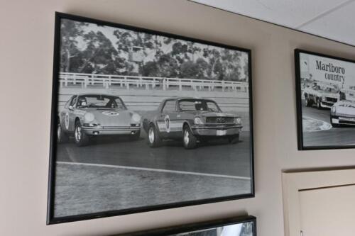 MUSTANG: A framed period photograph of Bryan Thomson leading Alan Hamilton, signed and inscribed on verso by Bryan