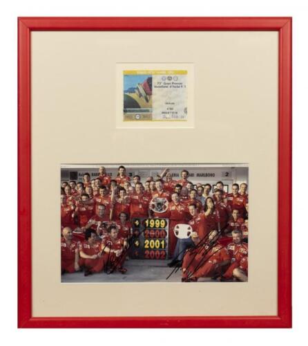 FERRARI: A signed team photograph of Scuderia Ferrari celebrating the victory at Italian Grand Prix- Monza - 2002 with an event ticket of the race
