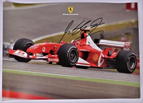SCHUMACHER: A colour picture of Michael Schumacher driving a Ferrari F1 car. Signed by Michael Schumacher