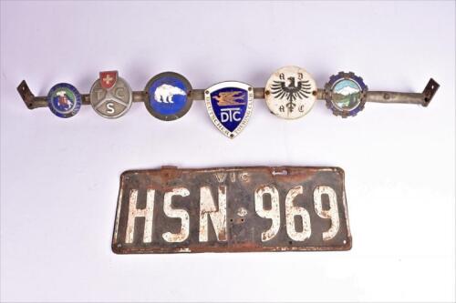 GRILL BADGES: A bar grill badge with various enamelled badges, removed from Bryan Thomson Austin Healey