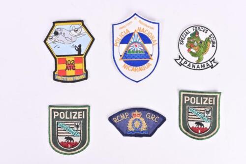 INTERNATIONAL CLOTH BADGES: Six international cloth badges. German 'POLIZEI' cloth badges