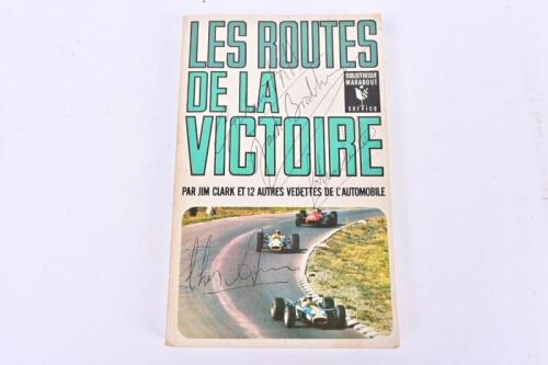 F1 DRIVERS: 'LES ROUTES DE LA VICTORIE' softcover book - front cover signed by four former F1 drivers Chris Amon, Sir Jack Brabham, Graham Hill, John Surtees