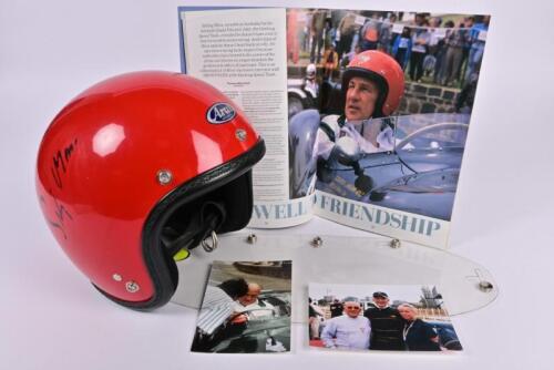 MOSS: A red Arai open faced helmet worn by Stirling Moss at the 1990 Geelong Speed Trials. Helmet signed by Stirling Moss and Sir Jack Brabham