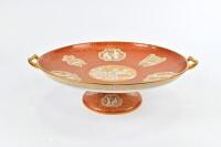SPODE COPELAND: A Spode Copeland tazza, circa 1960 with gilt classical Greek scenes on a red ground, Greek key border and gilded handles<br>11cm high, 39.5cm across the handles