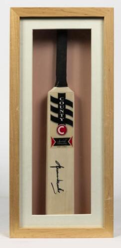 SHANE WARNE: A framed miniature cricket bat signed by Shane Warne, inscribed verso: Shane Warne, Australian Team of Century
