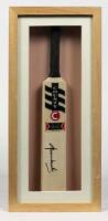 SHANE WARNE: A framed miniature cricket bat signed by Shane Warne, inscribed verso: Shane Warne, Australian Team of Century