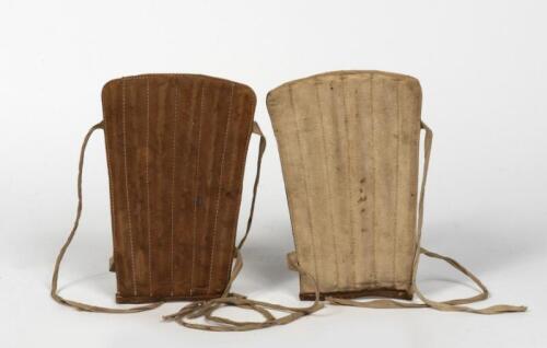 SHIN PADS: A pair of vintage leather shin pads