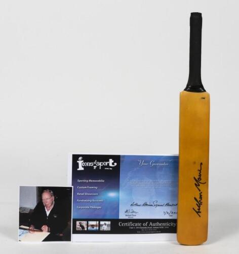 ARTHUR MORRIS: A miniature cricket bat signed by Arthur Morris, with certificate of authenticity and photo of the bat being signed