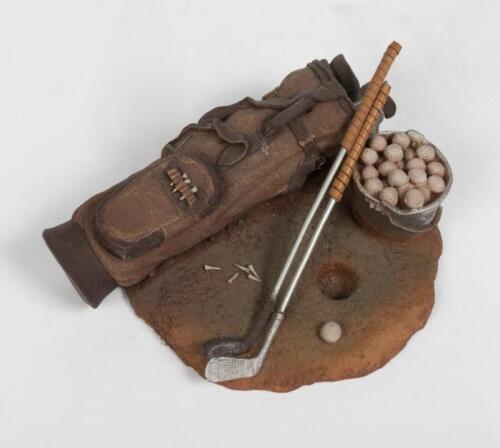 GOLFING DIORAMA: A ceramic golfing DIORAMA feature and golf bag, clubs and bucket of balls, 17cm diameter