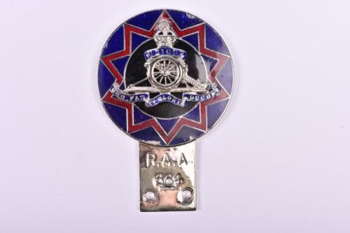 R.A.A: A Royal Australian Artillery car badge by J.R.Gaunt, London, blue and red background with central emblem and Latin motto, membership number '664', mounting holes; measures 8cm in diameter.