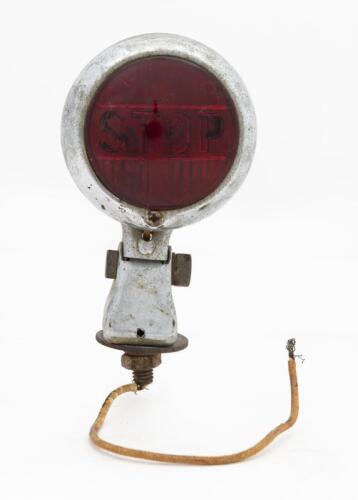 STOP LAMP: A ruby glass stop lamp with 'STOP" mounded into the glass. Marked 'NTD 402'