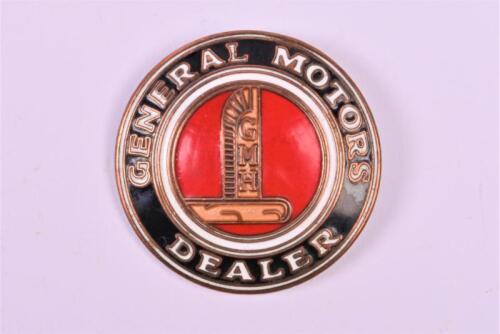 GM: An early Australian General Motors Dealer brass and enamel convex badge by Simpson, Adelaide
