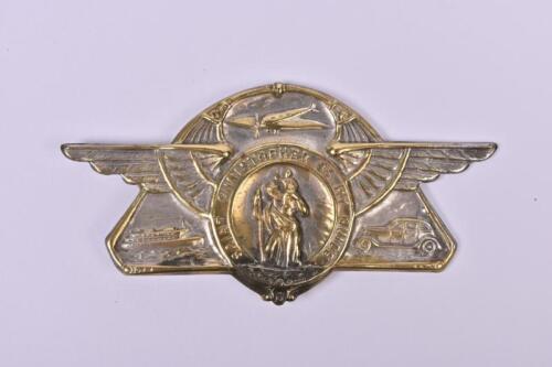 ST. CHRISTOPHER: A small 1930s pressed brass badge with winged Christopher. Depicts boat, plane and car