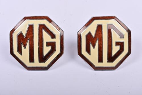 MG: Two 'M.G' octagonal convex enamel badges, brown text and surround, cream background