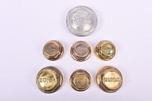 BUICK: Seven early wheel grease caps in alloy and brass