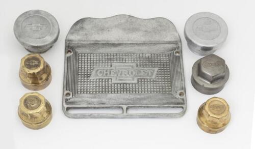 CHEVROLET: A collection of seven early Chevrolet items. Wheel Grease Caps & Alloy Running Board Scuff Plate