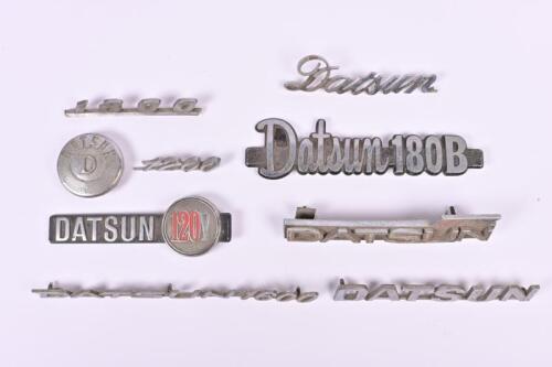 DATSUN: Nine DATSUN car badges. 'DATSUN 1600', 'Datsun 180B', '1200', '1880' car badges