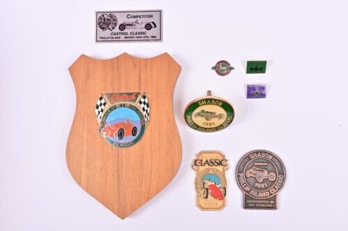 PHILLIP ISLAND: A group of badges and placards relating to Phillip Island. 1990 Castrol Phillip Island Classic (Limited Edition of 42) wooden shield