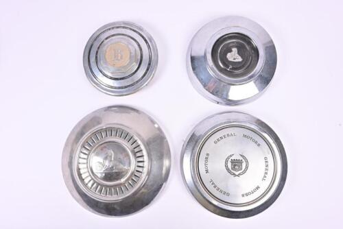 HUBCAPS: A group of four hubcaps by Buick and Holden. Holden FX/FJ hub cap