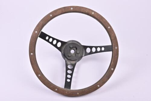 STEERING WHEEL: A wood rimmed, three spoke steering wheel