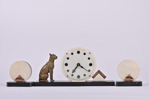 MANTLE CLOCK GARNITURE: An Art Deco marble, slate and spelter 30 hour mantle clock garniture, the centre piece 20cm high, 41cm wide, 9cm deep