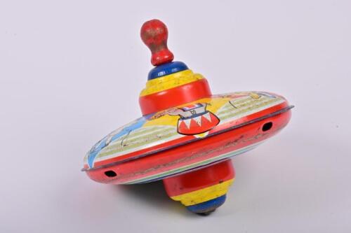 SPINNING TOP: A 1950s lithograph printed tin spinning top depicting circus scenes, 17cm high