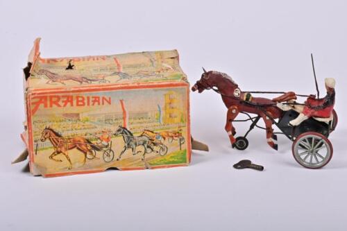 ARABIAN RACING HORSE: A 1950/60s West German clockwork Arabian harness racing toy in original box, 10cm high