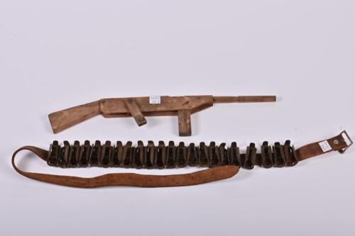 POP GUN: A mid-20th century handmade toy pop gun and a bullet belt, the toy gun with working hand crank, 42cm long