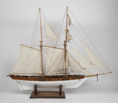 MODEL SHIP: A model of a topsail schooner sailing ship on stand, lifeboat detached, 100cm long, 83cm high