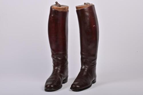 RIDING BOOTS: A pair of early 20th century burgundy leather gentleman's riding boots with boot lasts, 48cm high