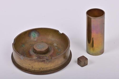TRENCH ART: A WWII Trench art group, comprising an ashtray made from a 1941 brass artillery shell and dice shaker with die, the ashtray 10.5cm diameter