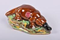 ROSEDALE: A circa 1958 New South Wales Rosedale Pottery slip cast figure of a platypus, bears label to side and stamped to base: Modelled by Rosedale, 14 cm wide