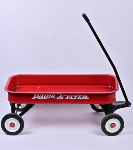 RADIO FLYER: A childrens red steel wagon, 36.5cm high, 100cm wide, 45cm deep