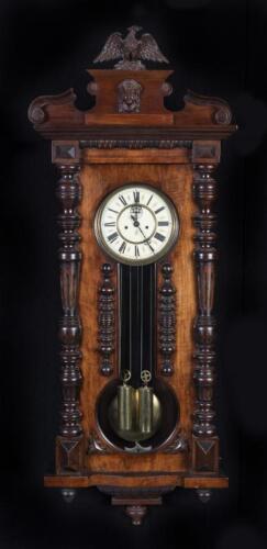 CLOCK : A circa 1890's German 'Vienna' two weight regulator wall clock by Gustav Becker, with enamel dial and fixtures bearing the GB insignia, in walnut case, hour and half hourly strikes, 129cm high, 49cm wide, 20cm deep (working)