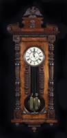 CLOCK : A circa 1890's German 'Vienna' two weight regulator wall clock by Gustav Becker, with enamel dial and fixtures bearing the GB insignia, in walnut case, hour and half hourly strikes, 129cm high, 49cm wide, 20cm deep (working)