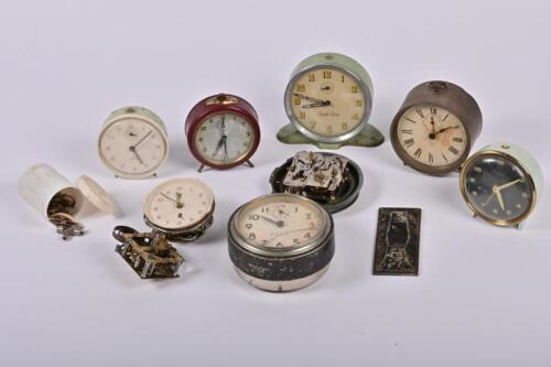 ALARM CLOCKS: A collection of vintage alarm clocks and parts, together with an Arnotts biscuit tin, the tin 15cm high, 24cm wide, 24cm deep