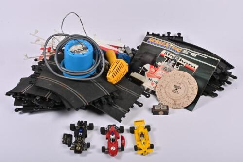 SCALEXTRIC: A 1970s Scalextric track, power prack with controllers, and three slot cars
