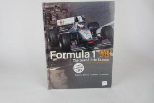 FORMULA 1: 1998 F1 Season Hardcover book signed by multiple F1 drivers. Includes Coulthard, Hakkinen, Villeneuve signatures.