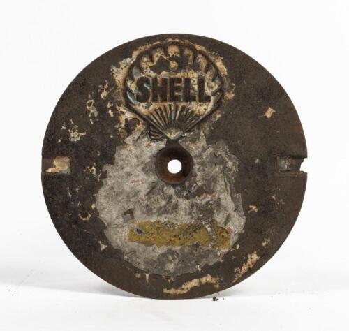 SHELL: A cast iron service station underground tank filler cover plate, Shell Clam with lettering inside shell, 27cm diameter. Original condition